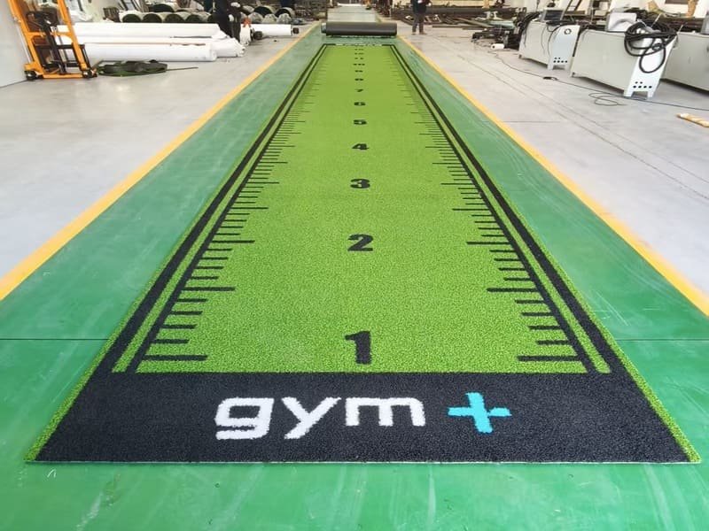 Barefoot athletes performing floor exercises on soft turf